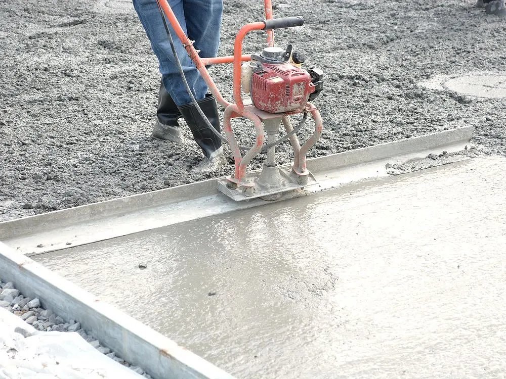 A power trowel giving fresh concrete a smooth finish