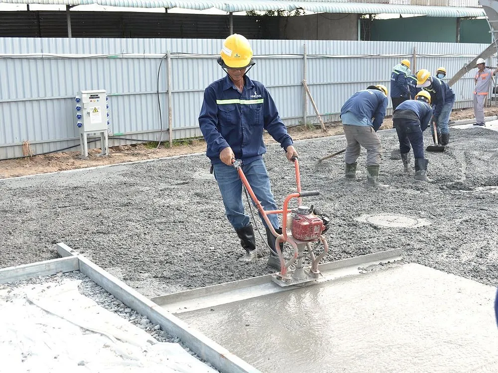 Fresh concrete being smoothed for a path